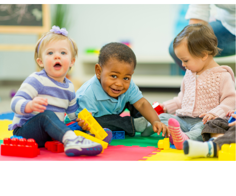 Babies playing on a mat