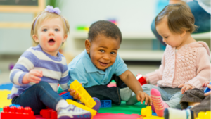 Babies playing on a mat