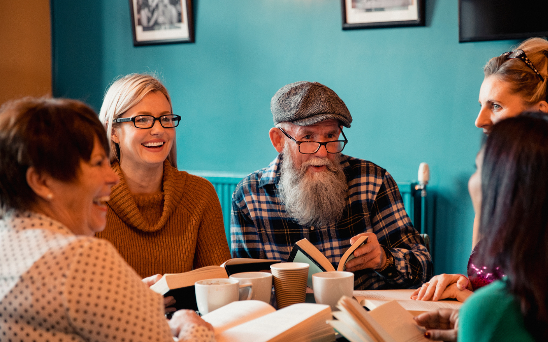 group of people discussing a book