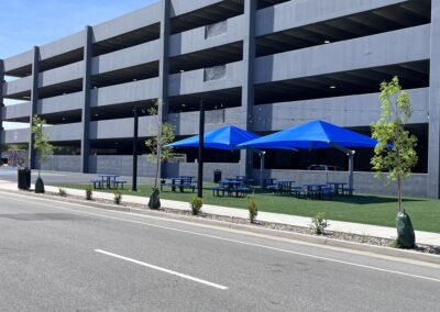 Blue umbrellas over picnic tables at the Fringe