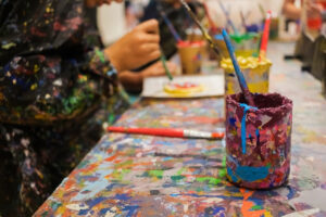 A long table covered in paint splatter