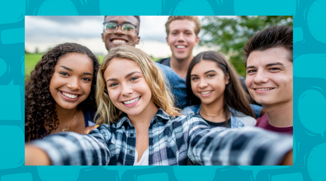 Teenagers taking a selfie atop a blue background