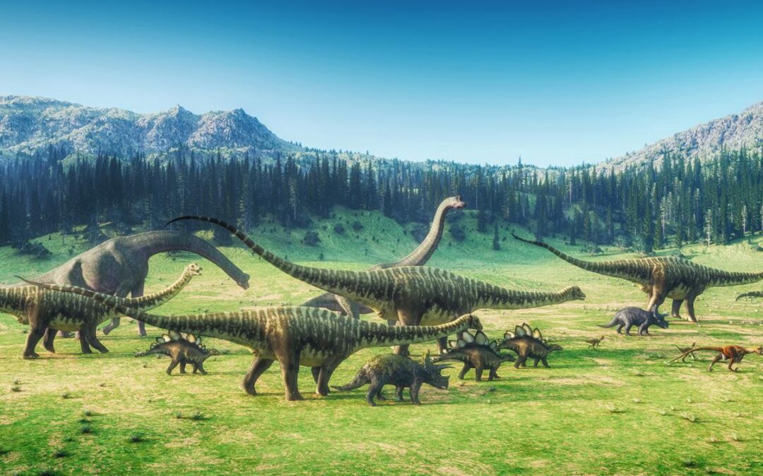 A pack of dinosaurs roam across a field