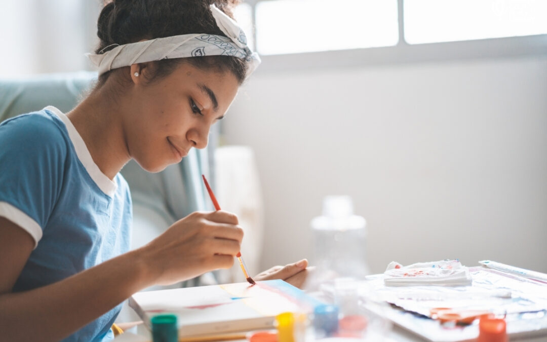 Teen painting with watercolors