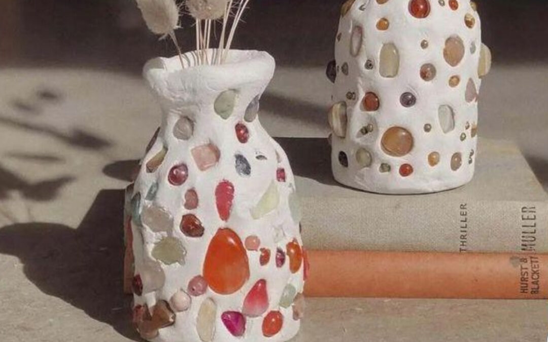 white clay vases decorated by shells and beads