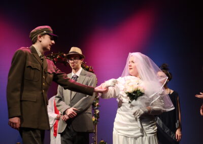 A bride pulling back from a person in univorm